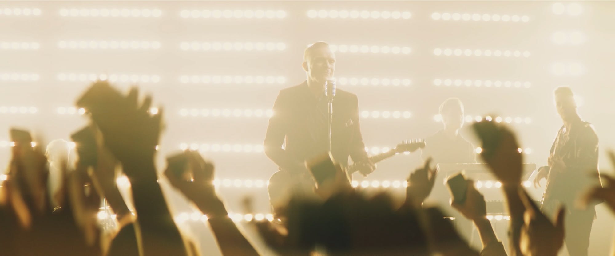 a man on an arena stage performing music