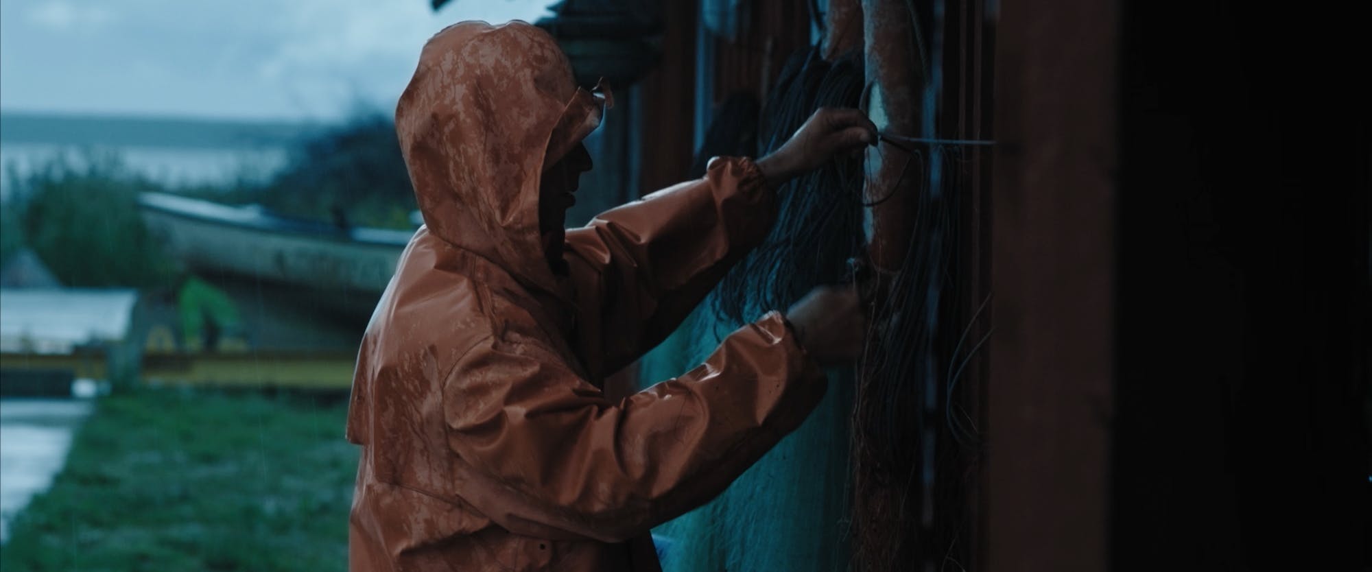 a fisherman cleaning fish nets