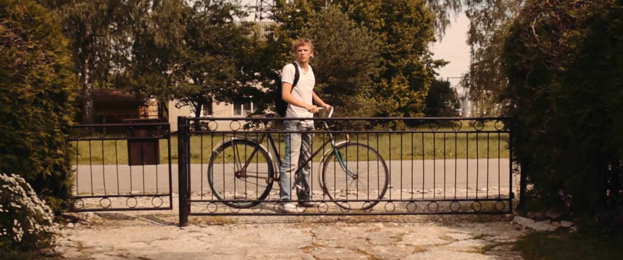 a young man behind the fence