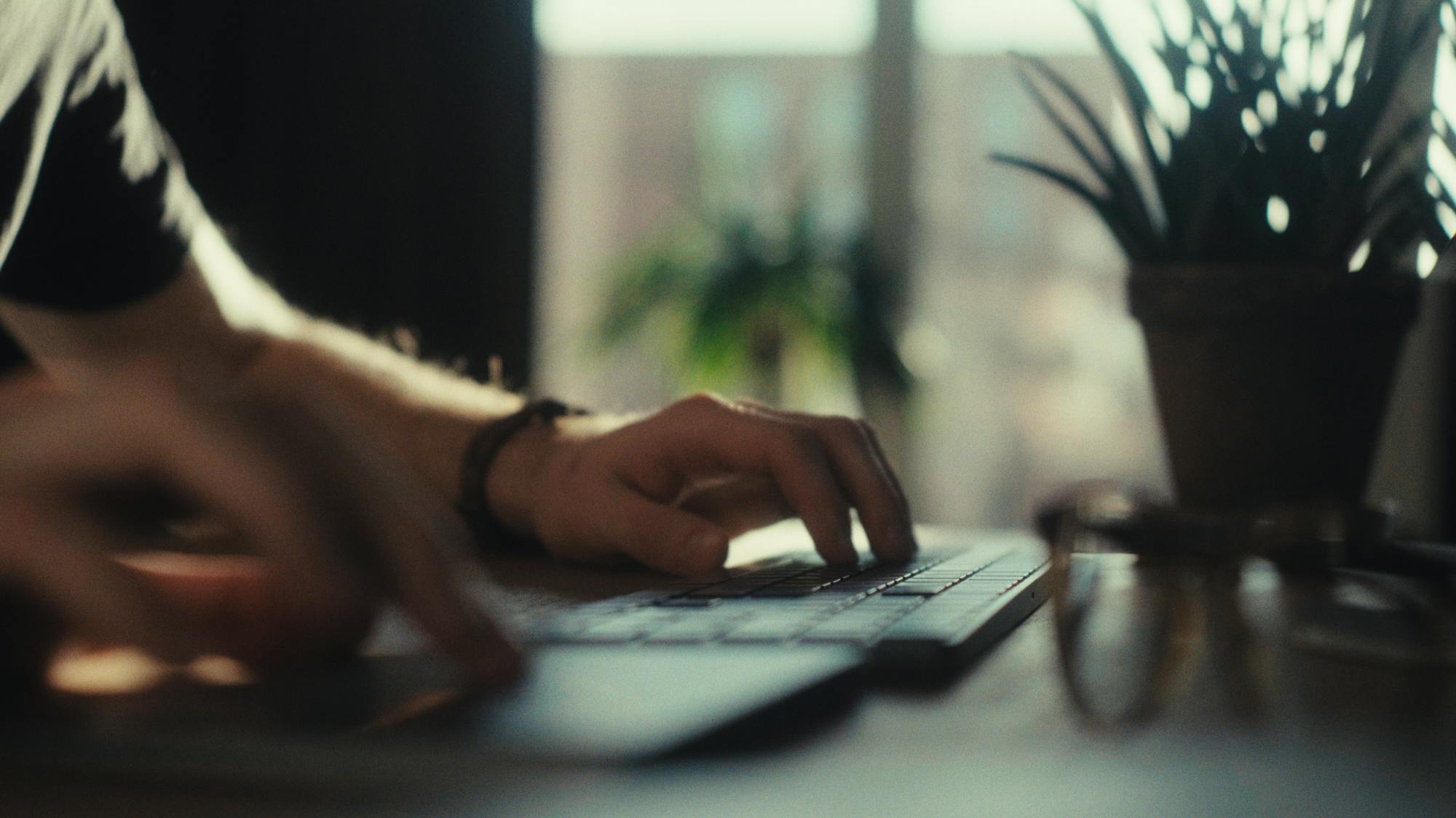 hands using a keyboard and a touchpad