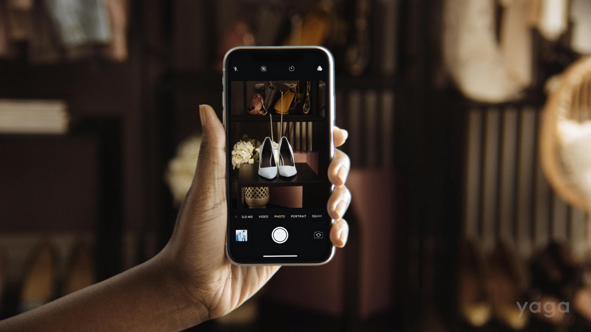 female hands holding a phone and taking a photo of shoes